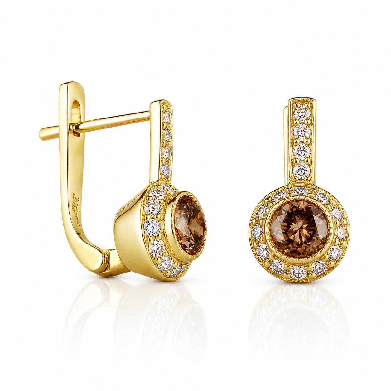 a pair of gold earrings with diamonds, showcasing their intricate design and sparkling appearance.