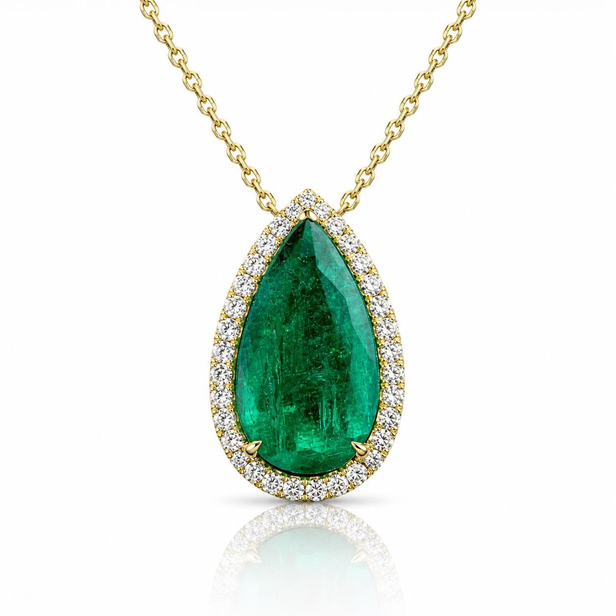 A gold necklace with a large, bright green emerald gemstone surrounded by smaller diamonds.