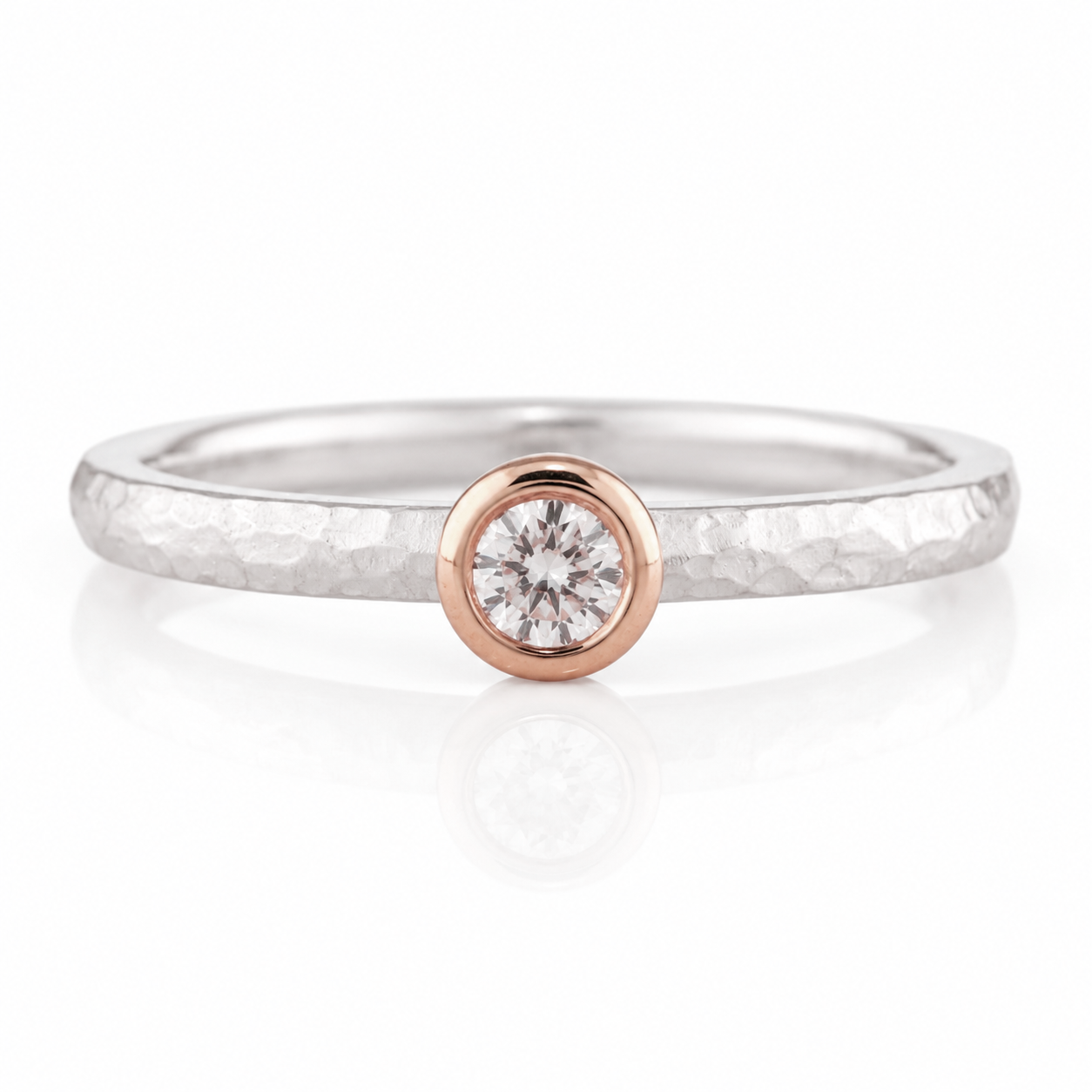 A silver ring with a large, round diamond set in the center.