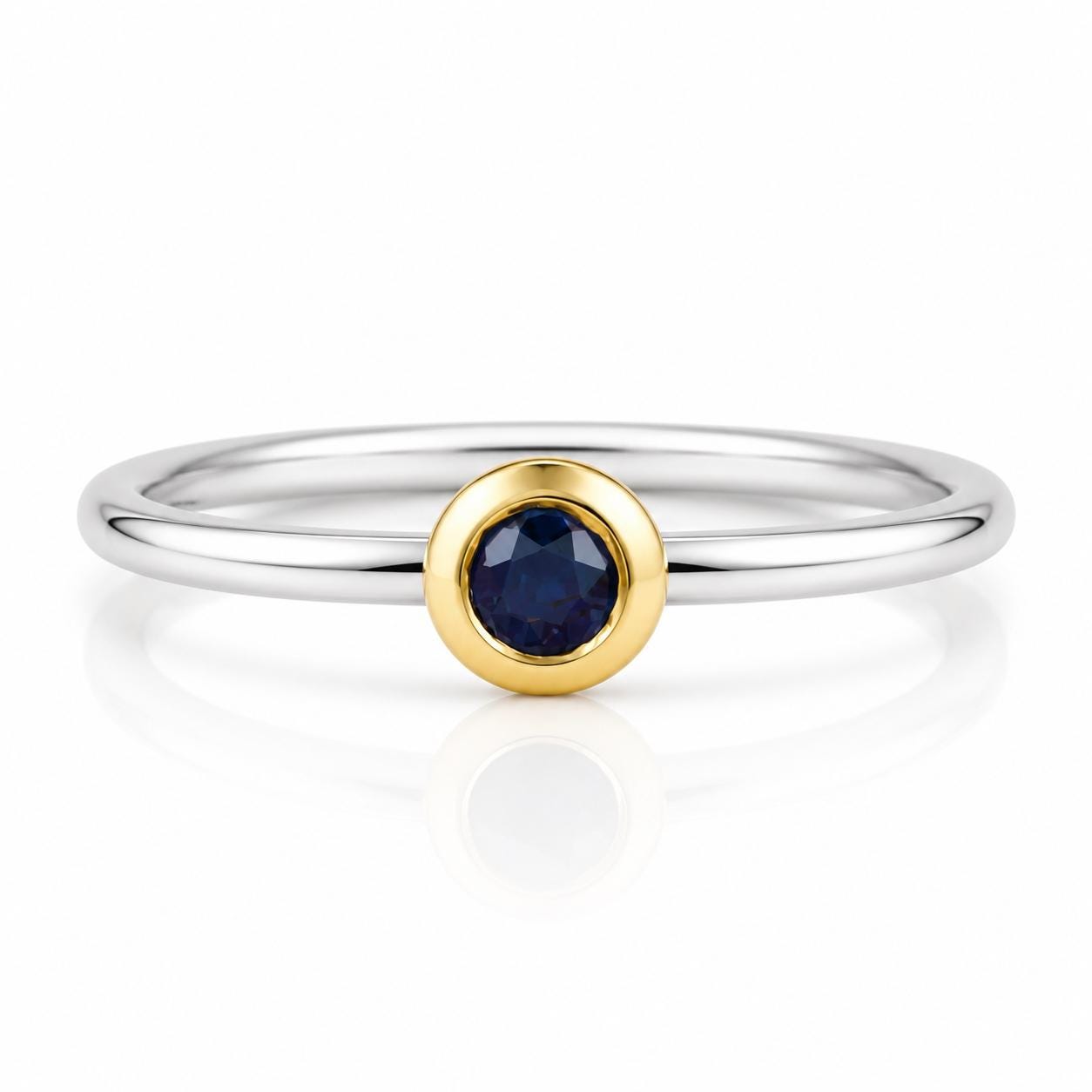 A silver ring with a blue gemstone in the center.