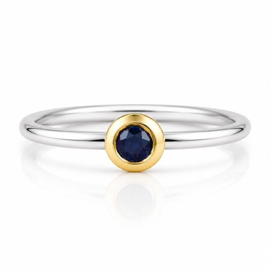 A silver ring with a blue gemstone in the center.