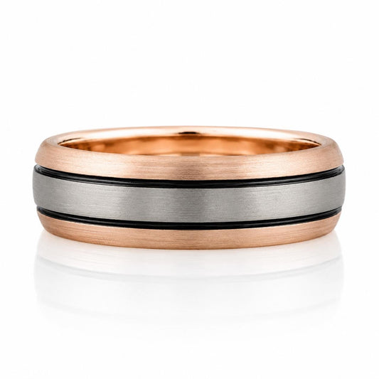 A gold and silver ring with a metallic band featuring a striped pattern.