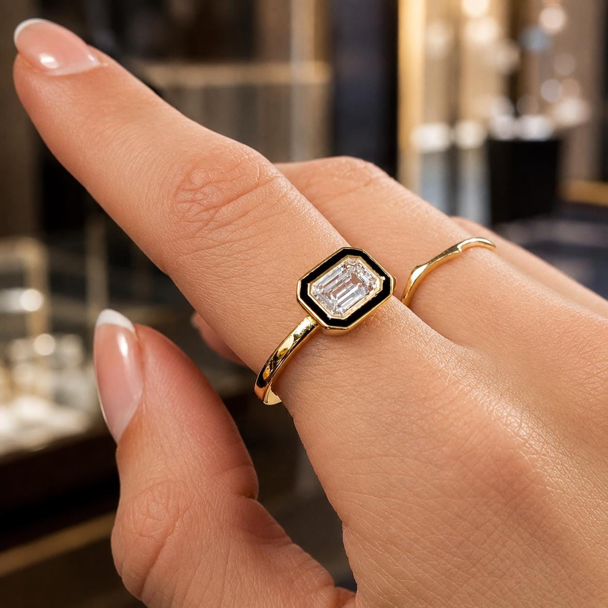 A close-up of a person's hand wearing a gold ring with a large diamond in the center.