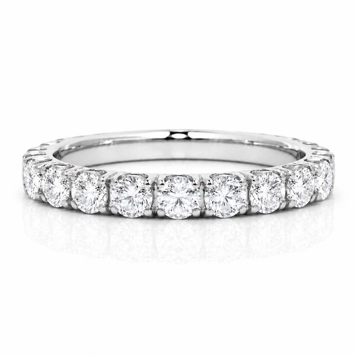 A diamond ring with a row of round diamonds set in a silver band.