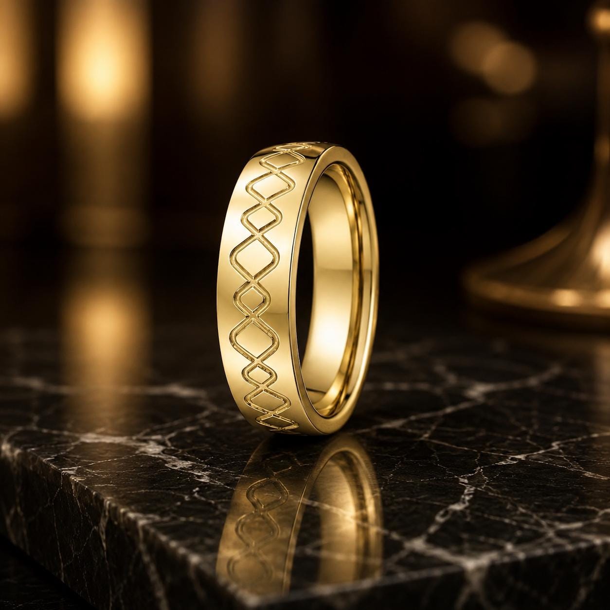 A gold ring with a diamond pattern sits on a black marble surface, reflecting the light.