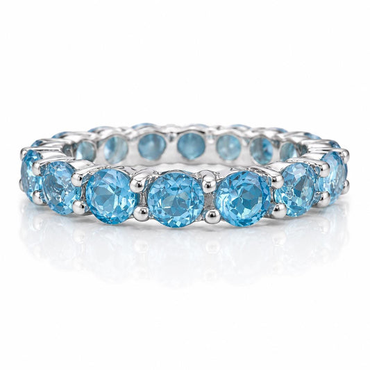 A silver band with a row of blue gemstones, likely diamonds, set in a decorative pattern.