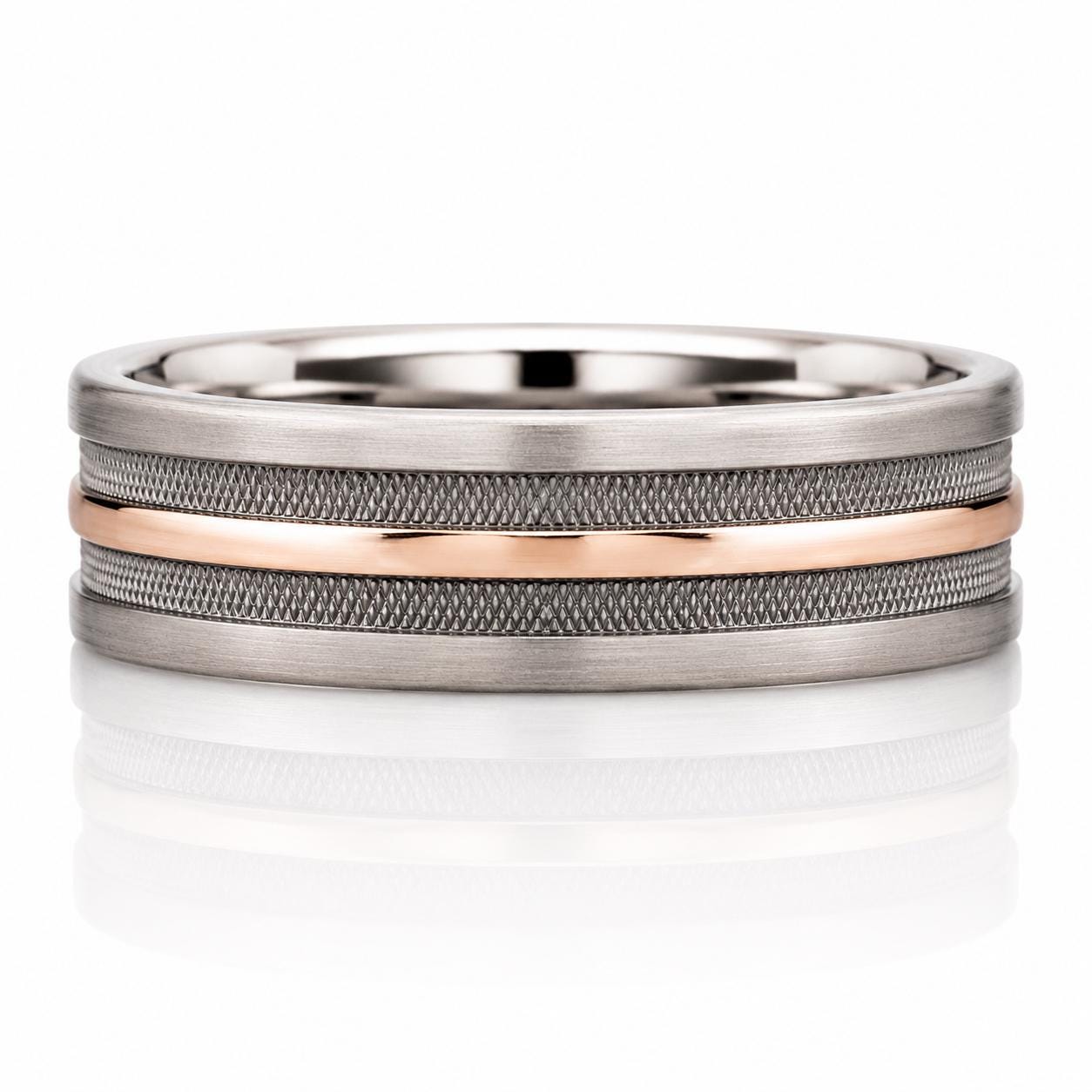 A silver and gold ring with a metallic texture and a thin, horizontal band.