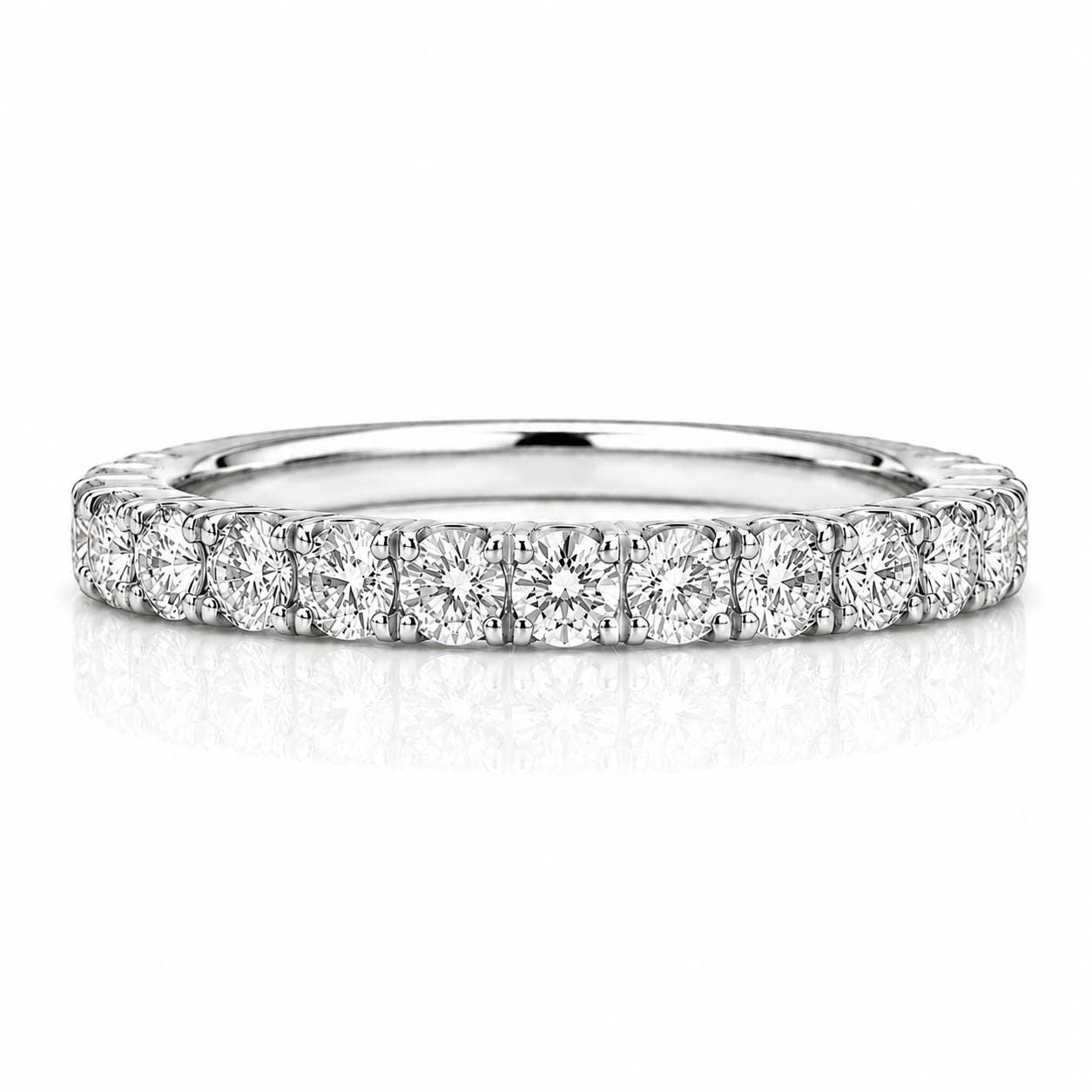 A diamond-encrusted ring with a row of round diamonds set in a silver band.