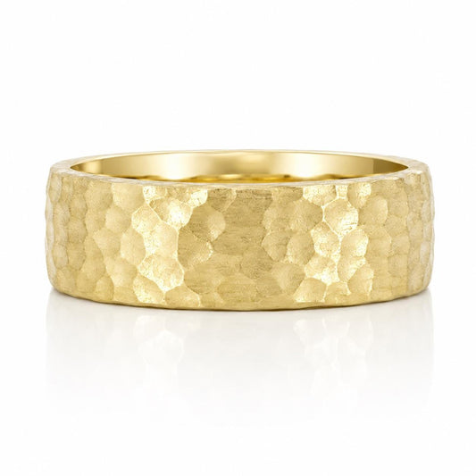 A gold ring with a textured, embossed surface.