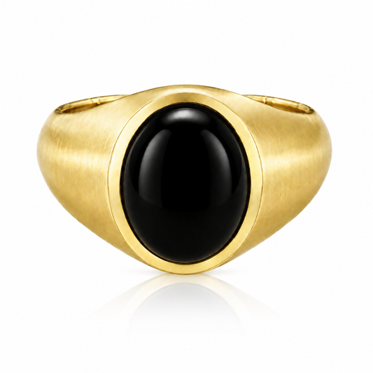 A gold ring with a black gemstone, likely a diamond, in the center.