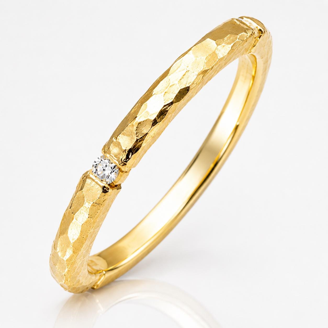 A gold ring with a diamond set in the center.