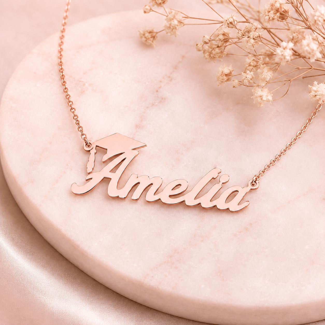 A necklace with the name "Amelia" engraved on it, resting on a marble surface.