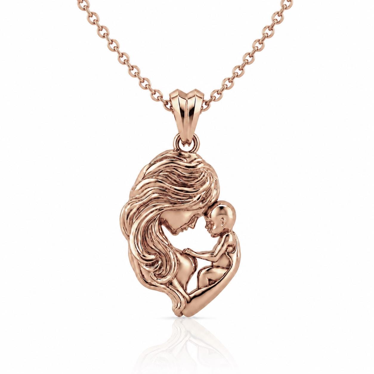 A pendant in the shape of a woman's face with a baby in her arms, made of a shiny, reddish-brown material.