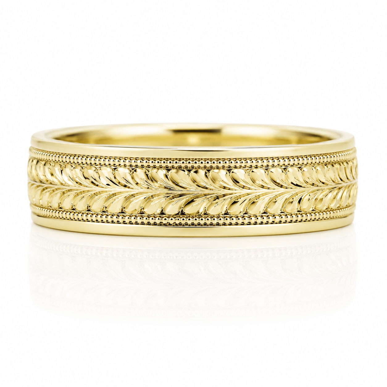 A gold ring with a decorative band featuring a leaf-like pattern.