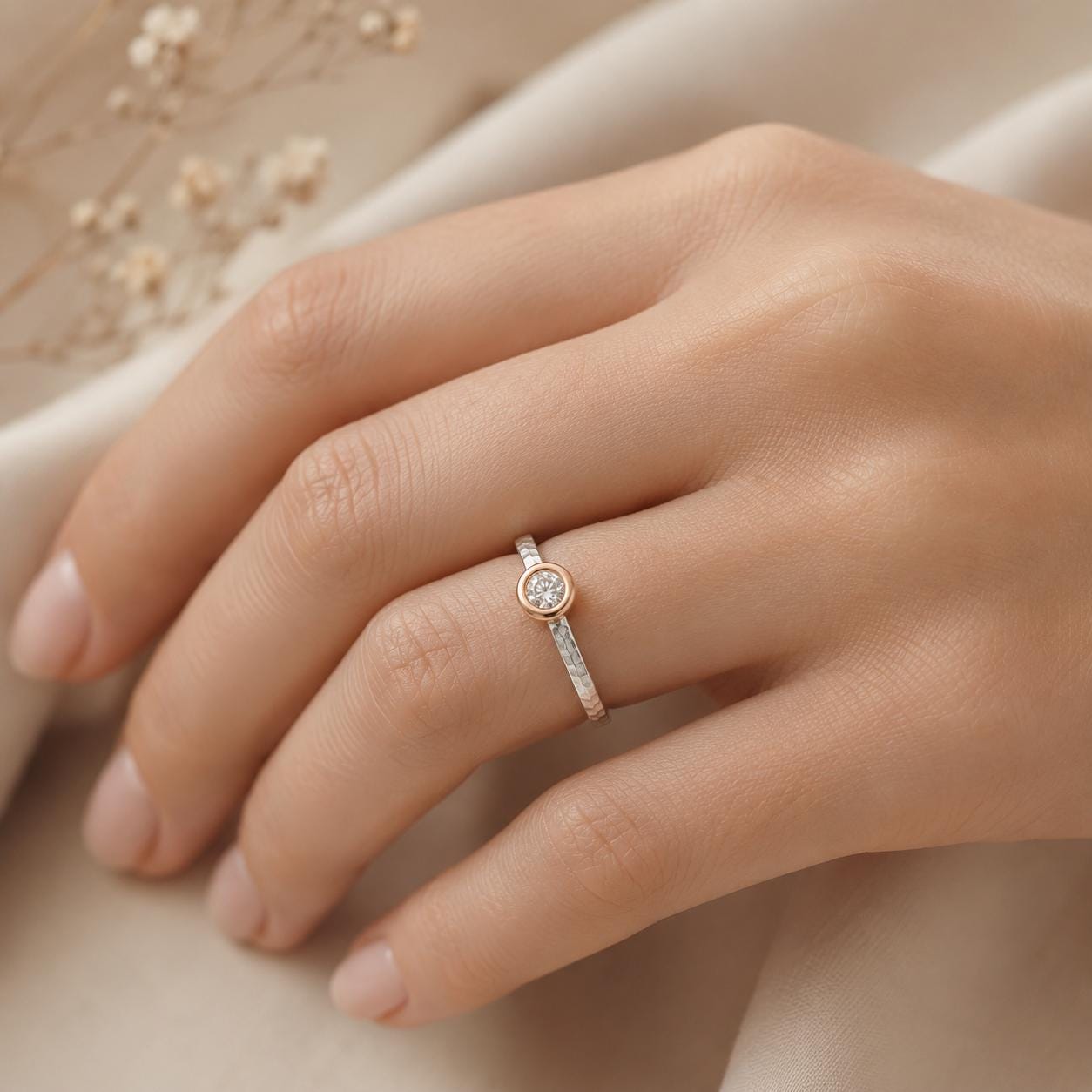 A close-up of a hand wearing a gold ring with a small diamond.