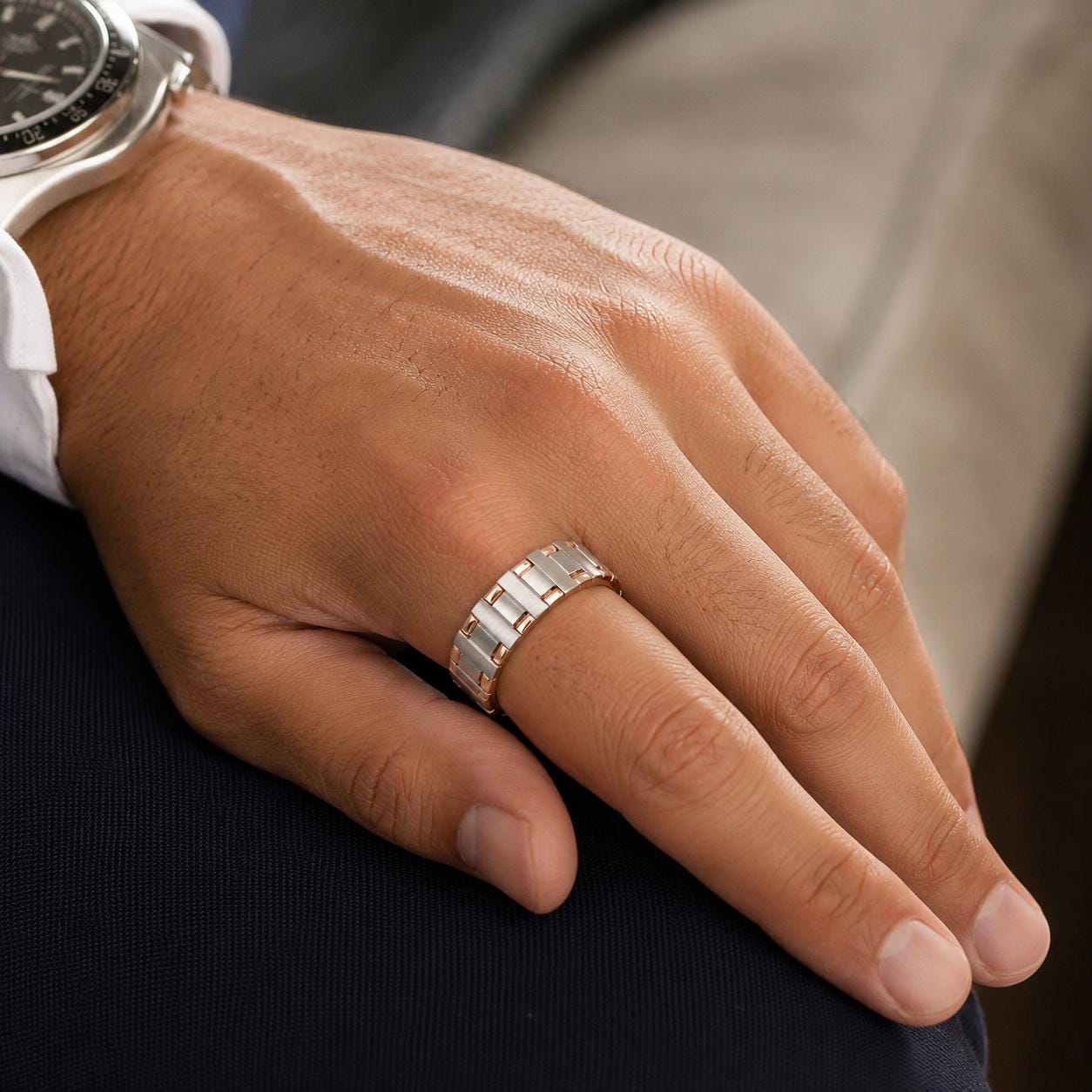 A close-up of a person's hand wearing a ring on the ring finger.
