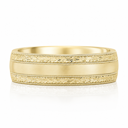 A gold ring with a decorative band featuring leaf patterns.