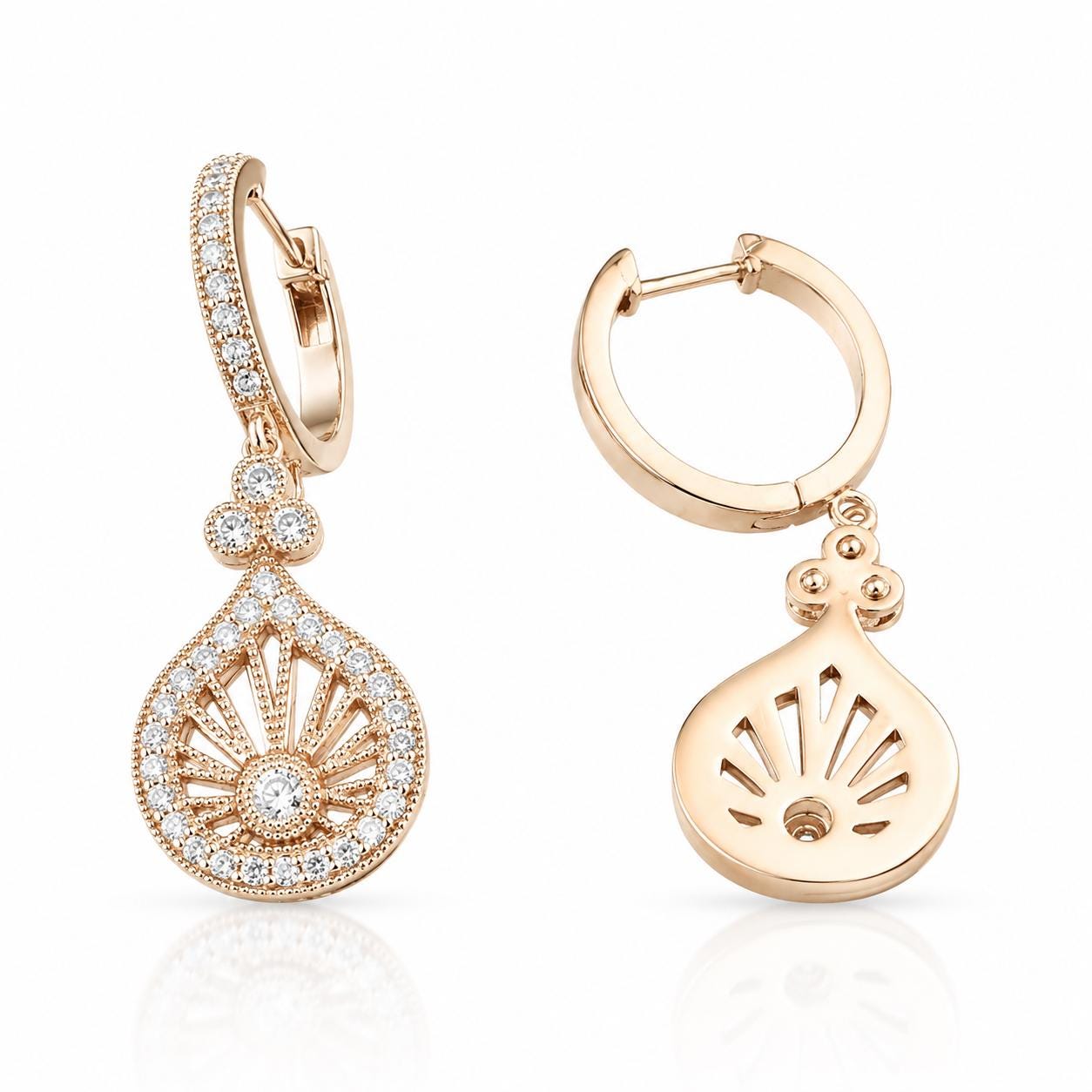 two gold earrings with intricate designs and sparkling gemstones.